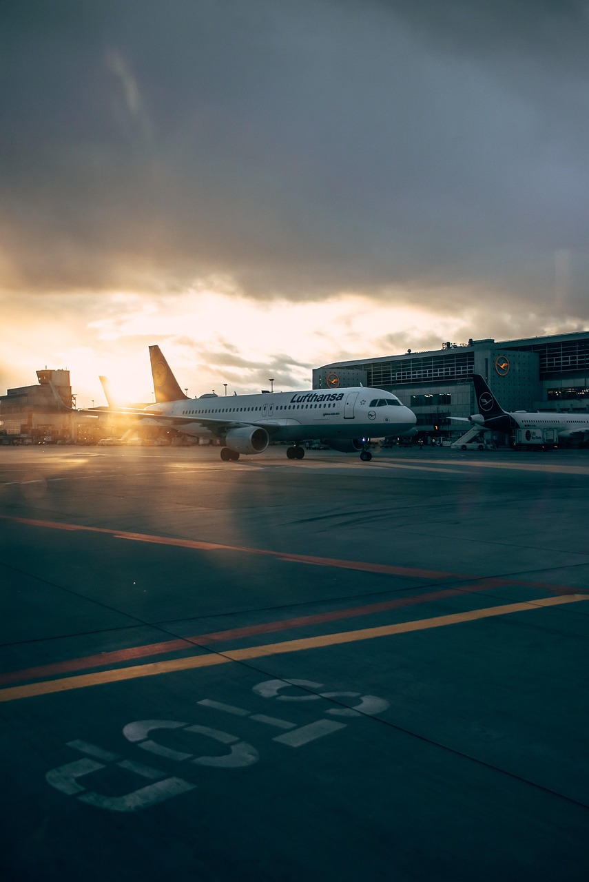 airplane, airport, aircraft, vehicle, runway, jet, flight, sky, tarmac, airliner, sunset, outdoors, nature, airport terminal, evening, air travel, plane, outdoor, transportation system, airline, road, transportation, travel, aviation, airfield, no person